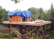The pine contoured rough exterior siding is on three walls and the cedar stain oil base protectant is applied.