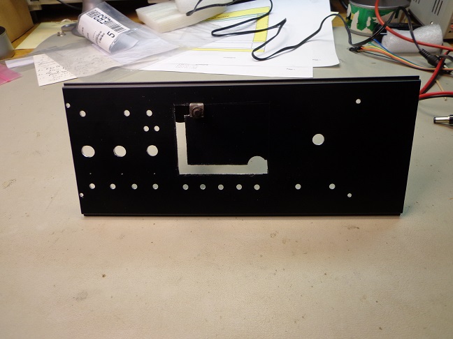 Hammond cabinet face after drilling, now cutting out the LCD viewing area with nibbling tool.
